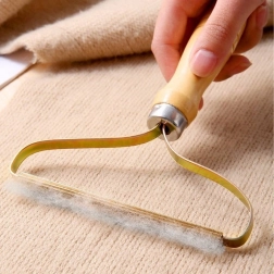 Manual lint remover for clothing and upholstery with wooden handle