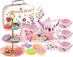 Tea set in a suitcase with cups, plates and pastries