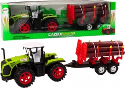 Zeleni kmečki traktor s prikolico za hlode