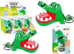 Green keychain with biting crocodile and bell