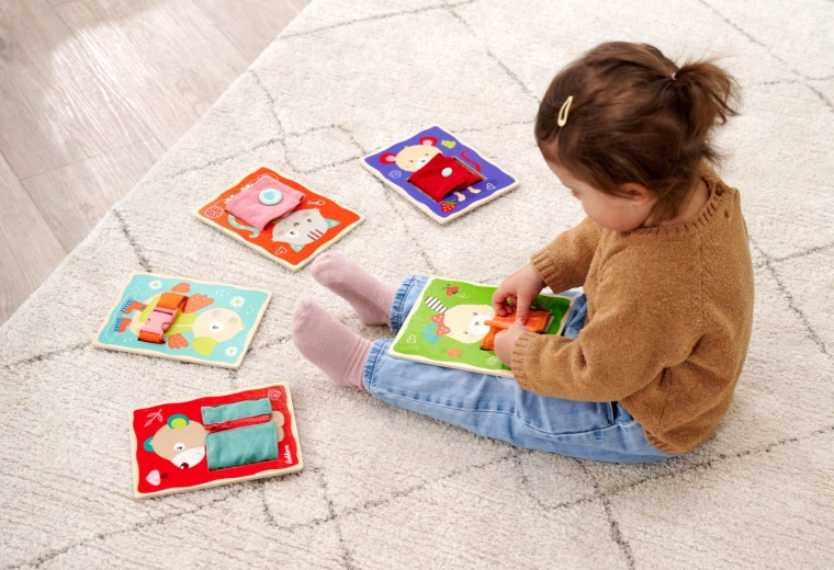 Learning to dress through play