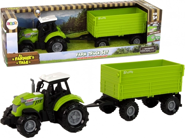 Zelený poľnohospodársky traktor s prívesom