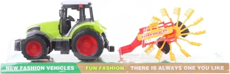 Plastic tractor with hay tedder for kids