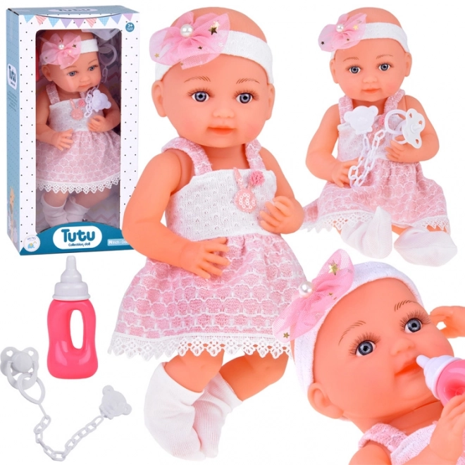 Rubber Baby Doll in Pink Dress with Bottle and Pacifier