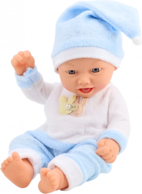Baby pop in blauwe pyjama met muts met pompon