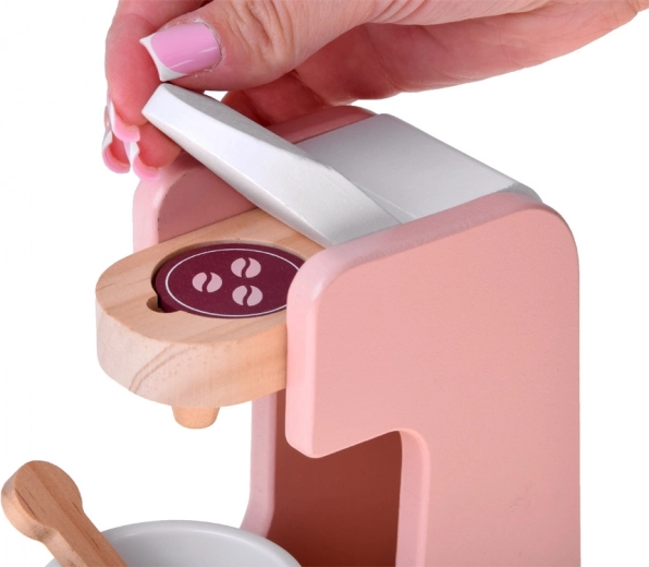 Capsule coffee maker with cup and spoon