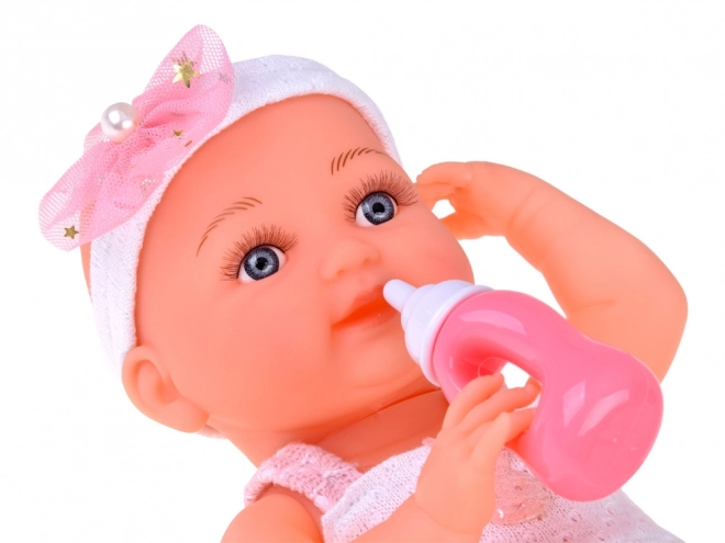 Rubber Baby Doll in Pink Dress with Bottle and Pacifier