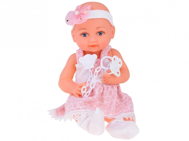 Rubber Baby Doll in Pink Dress with Bottle and Pacifier