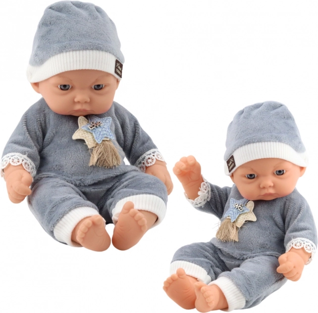 Baby doll in gray pajamas with a hat