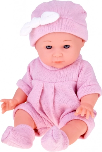 Realistic baby in a pink knitted outfit