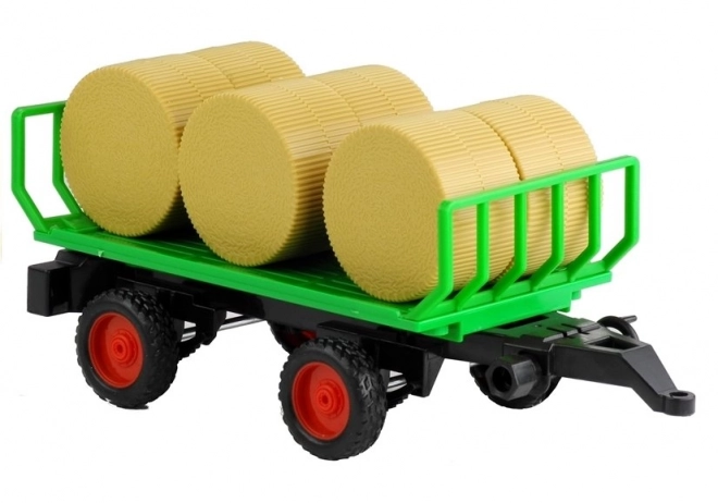 Zelený traktor s prívesom na seno so svetlami a zvukmi