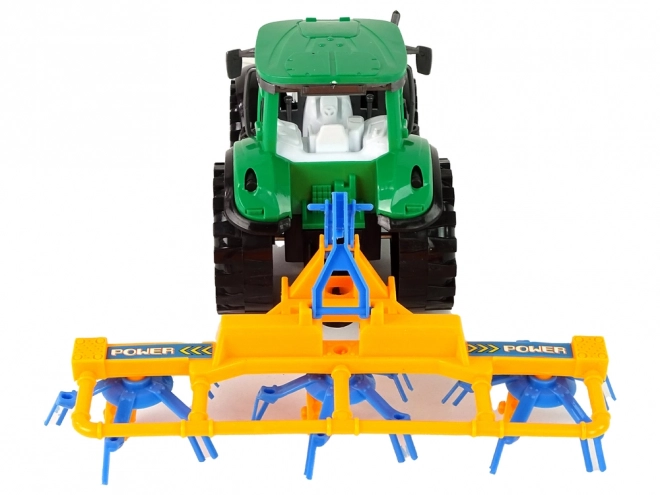 Green Tractor with Friction-Driven Hay Rake